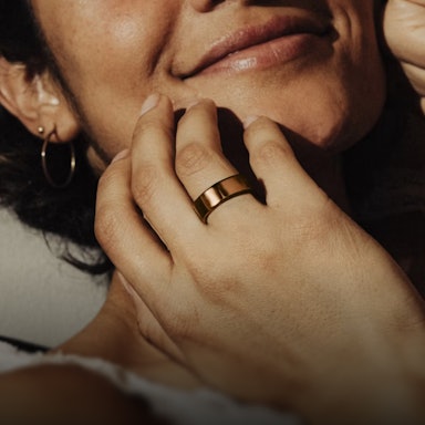 Close up of a person's hand with a Rose Gold Oura Ring 4 on their finger