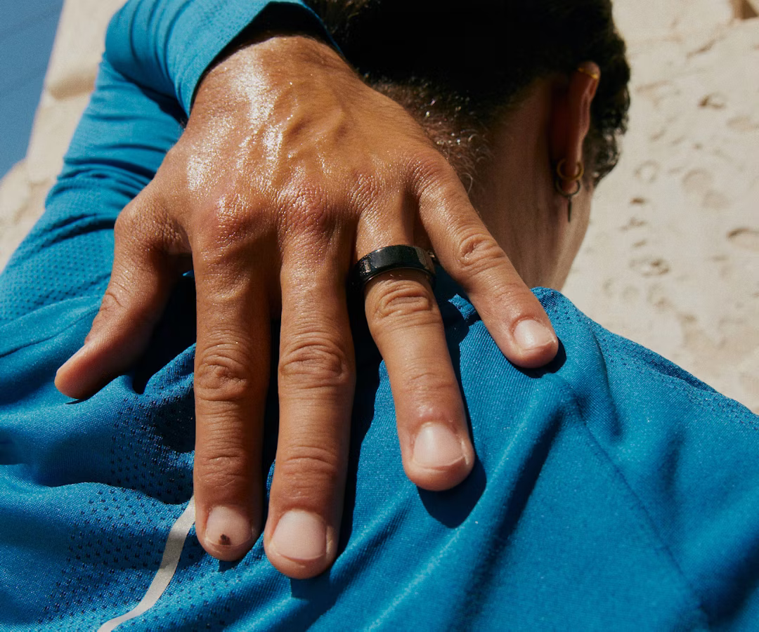 A person wearing a Black Oura Ring 4 stretching
